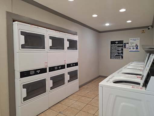 A row of white ovens are lined up in a room.