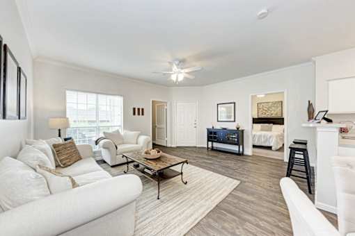 A living room with a white couch and a coffee table.