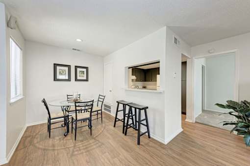 A dining room with a white table and chairs.