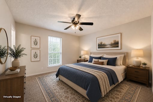 A bedroom with a bed, two nightstands, and a ceiling fan.
