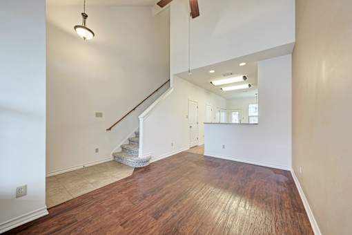 A room with a staircase and wooden floors.