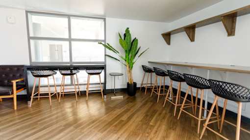 A room with a long table and chairs.