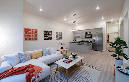 A living room with a white couch and a coffee table.