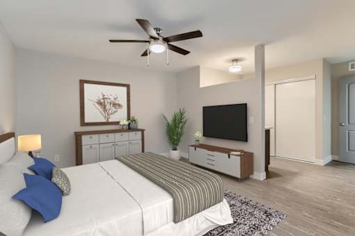 A bedroom with a bed, a ceiling fan, and a television.