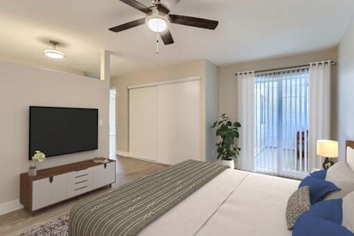 A bedroom with a large bed, a flat screen TV, and a ceiling fan.