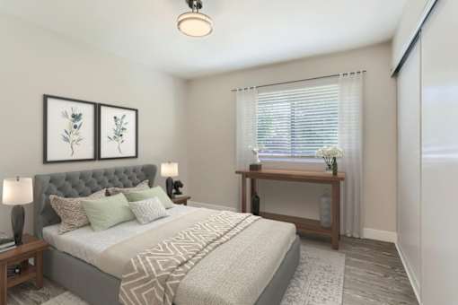 A bedroom with a large bed and a wooden table.
