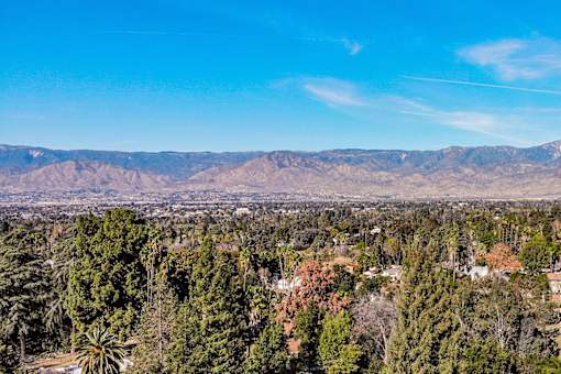 A view of a mountain range with a clear blue sky above.