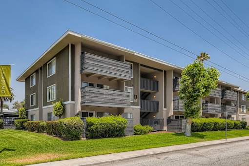 A modern apartment building with a clear blue sky above.