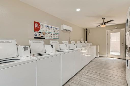 A laundromat with rows of washers and dryers.
