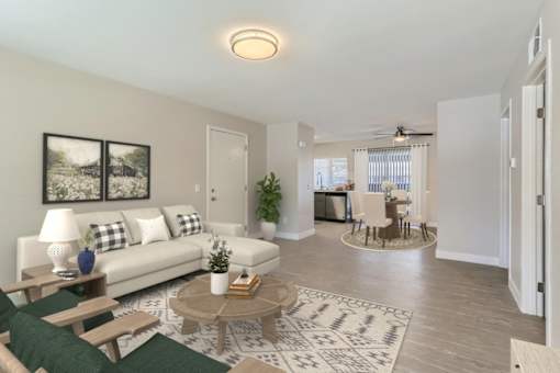 A living room with a white couch, a coffee table, and a rug.