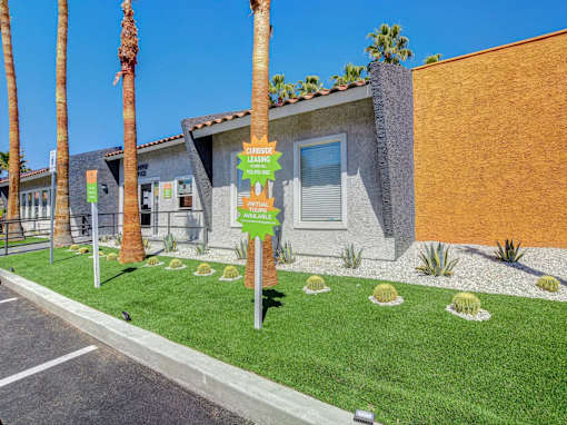 A house with a sign that says "Coupons Available" in front of it.