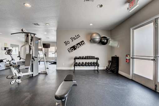 A gym with a sign that says "No Pain No Gain".