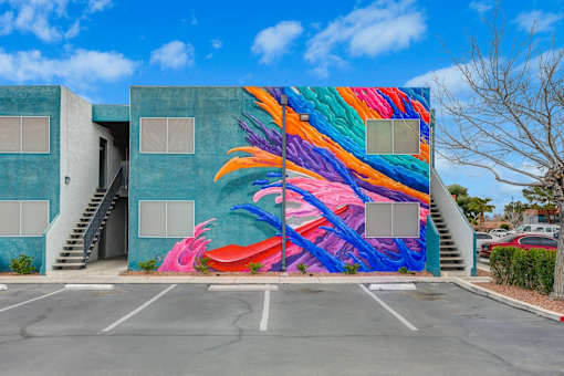 A colorful mural of a bird painted on a building.