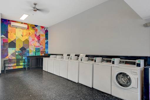 A row of washing machines in a laundromat.