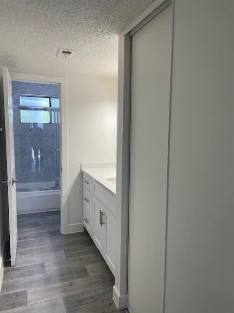 A white bathroom with a marble window seat.