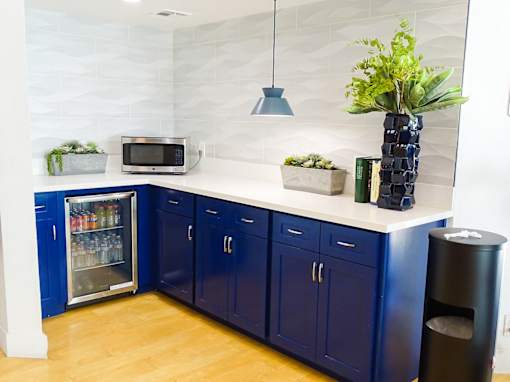 A kitchen with blue cabinets and a white countertop.
