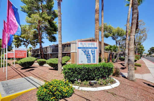 A sign for Rosewood Park is displayed in front of a building.