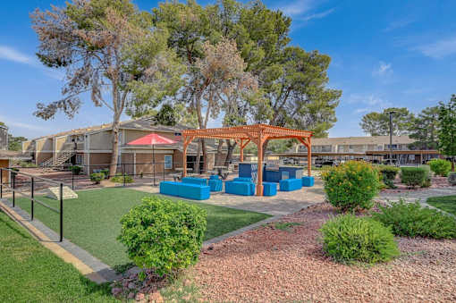 A playground area with a red swing set and blue play equipment.