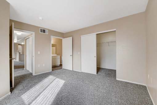 A room with a carpeted floor and white walls.
