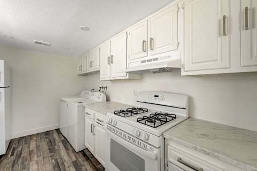 A white kitchen with a stove and oven.