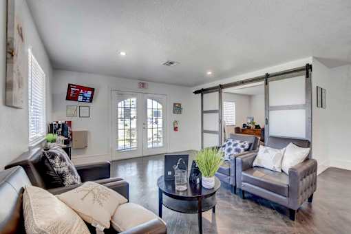 A living room with a grey couch and a coffee table.