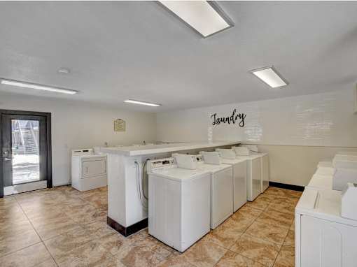 Laundry room with washers and dryers.