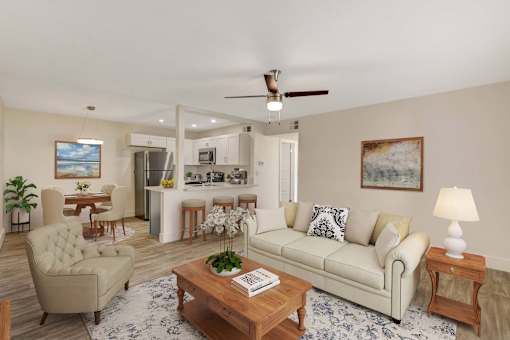 A living room with a beige sofa, a wooden coffee table, and a painting on the wall.