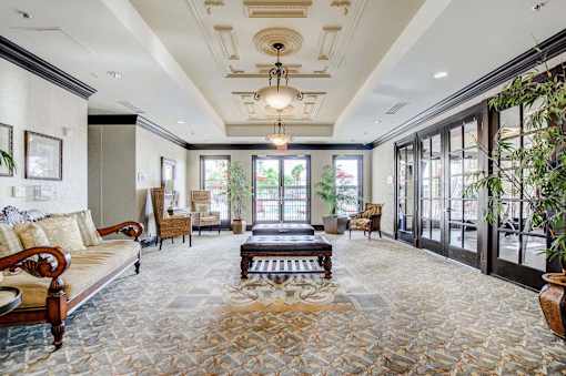 A living room with a couch, coffee table, and a chandelier.