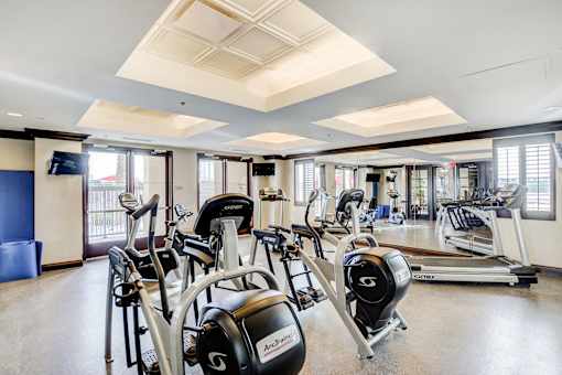 A gym with a row of Archer branded exercise bikes.