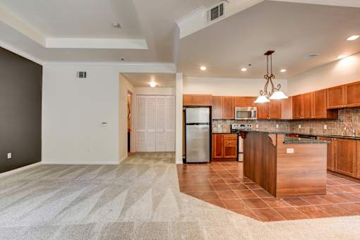 A kitchen with brown countertops and a white refrigerator.