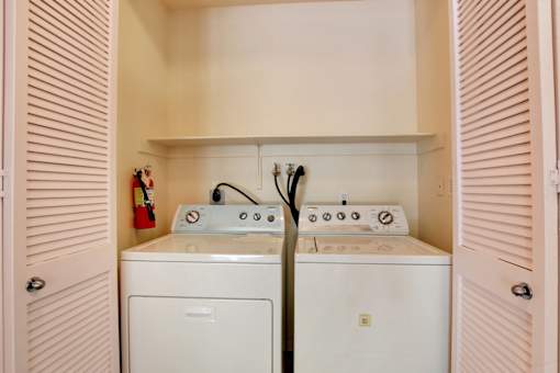 A white washing machine and dryer in a small laundry room.