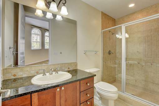 A bathroom with a sink, toilet, and shower.