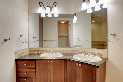 A bathroom with two sinks and a large mirror.