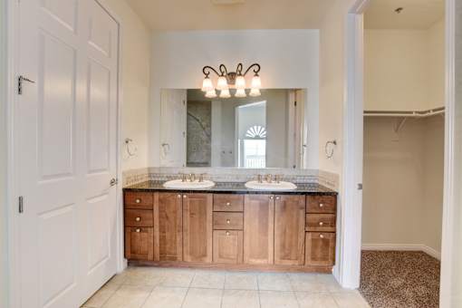 A bathroom with a vanity and a mirror.