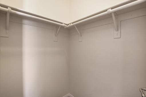 A white wall with a white pipe running along it.