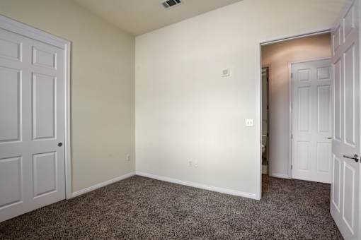 A room with carpeted floor and white walls.