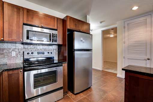 A kitchen with a stainless steel refrigerator and oven.