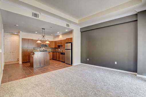 A kitchen with a refrigerator, microwave, and oven.