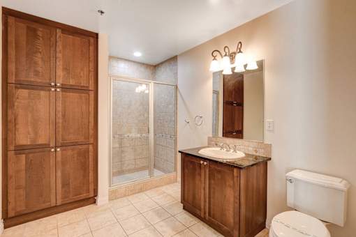 A bathroom with a toilet, sink, and shower.