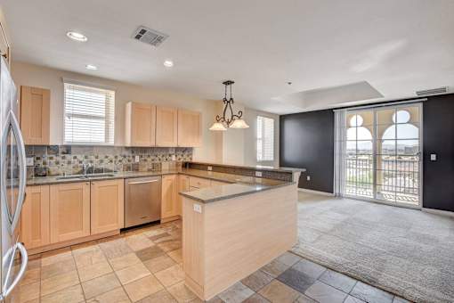 A kitchen with wooden cabinets and a tiled backsplash.