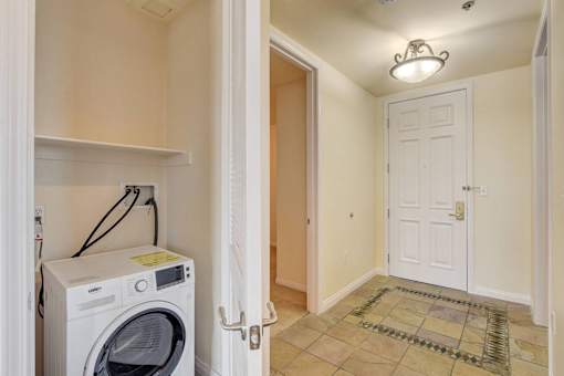 A small laundry room with a washer and dryer.