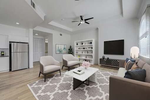 A living room with a brown couch, a white coffee table, and a ceiling fan.