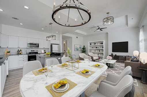 A modern dining room with a marble table set for a meal.