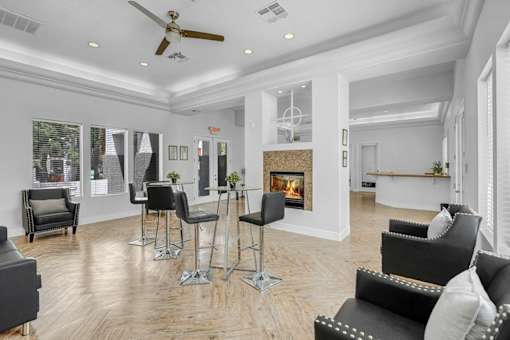 A living room with a fireplace and a ceiling fan.