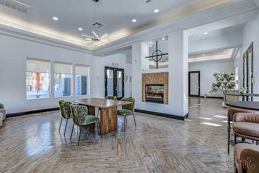 A room with a fireplace and a dining table.