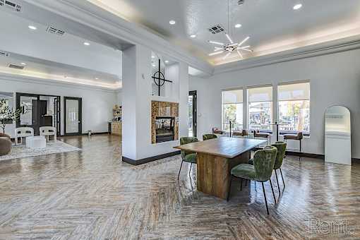 A large room with a wooden table and chairs.