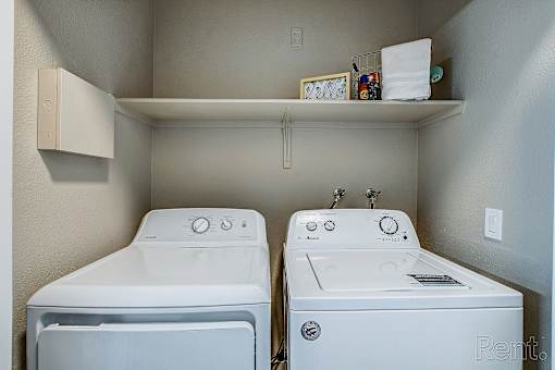 A small laundry room with a washer and dryer.