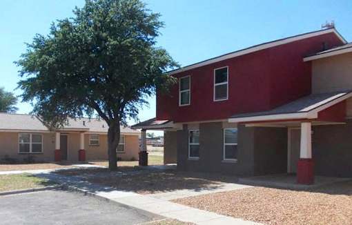 A red building with a tree in front of it.