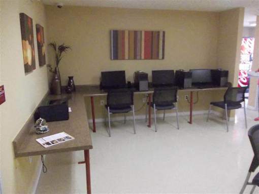 A conference room with a long table and chairs.
