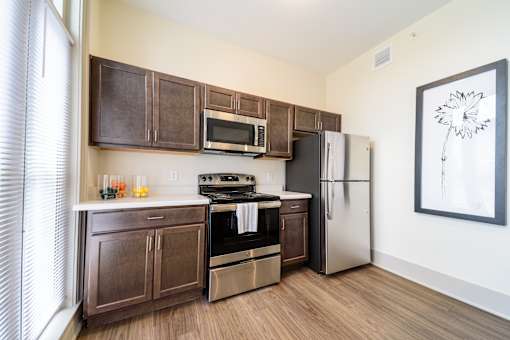 A kitchen with brown cabinets and a white refrigerator.